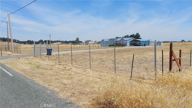 view of yard with a rural view