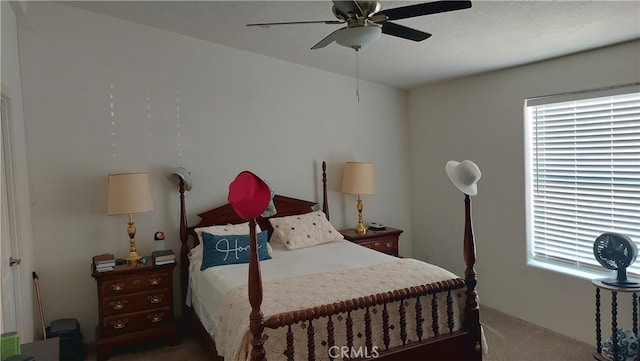 carpeted bedroom with a textured ceiling and ceiling fan