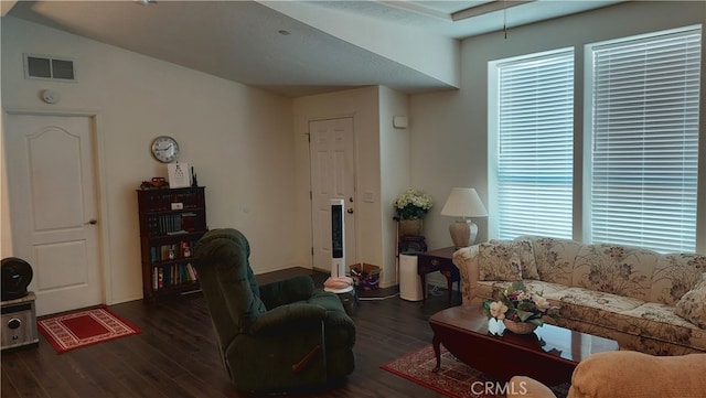 living room featuring dark wood-type flooring and vaulted ceiling