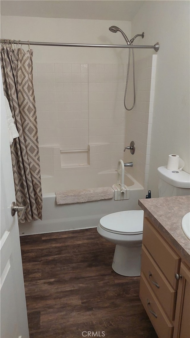 full bathroom with toilet, shower / tub combo with curtain, hardwood / wood-style flooring, and vanity