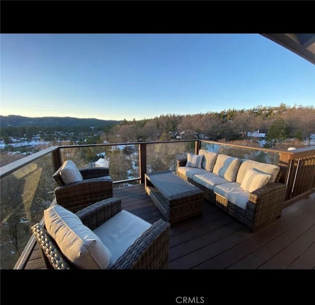 wooden deck with an outdoor living space