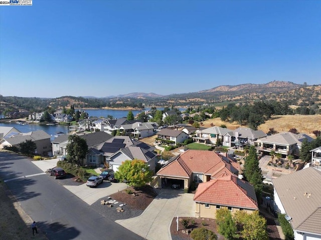 bird's eye view with a water and mountain view