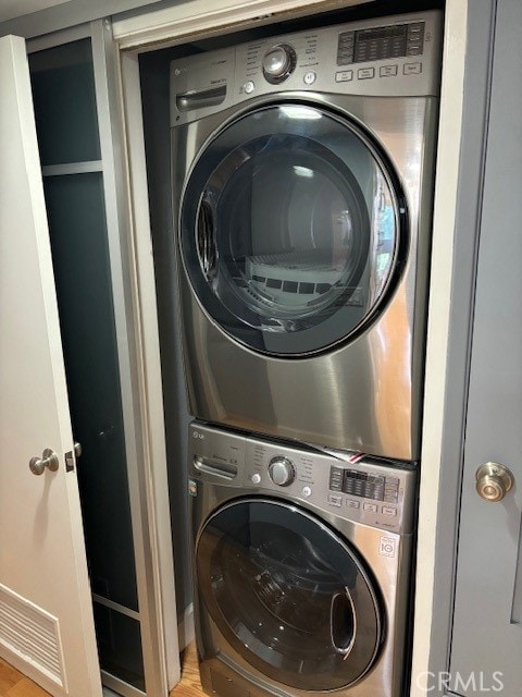 laundry area featuring stacked washer and dryer