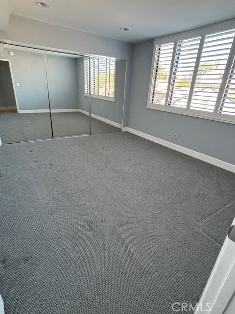 unfurnished bedroom with carpet and a closet