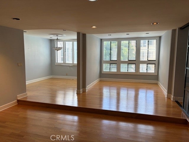 unfurnished room with light hardwood / wood-style flooring and a healthy amount of sunlight