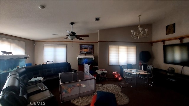 living room featuring vaulted ceiling, ceiling fan with notable chandelier, and plenty of natural light