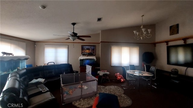 living room featuring lofted ceiling and ceiling fan with notable chandelier