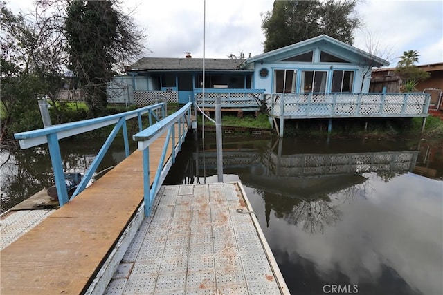 dock area with a deck with water view