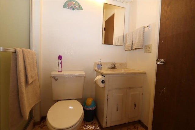 bathroom with tile patterned flooring, vanity, and toilet