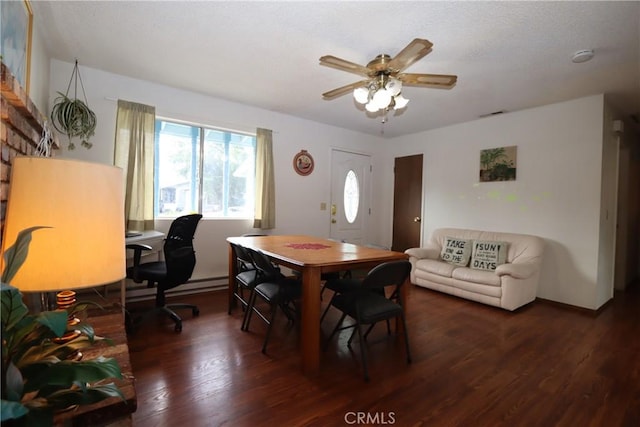 dining space featuring ceiling fan and dark hardwood / wood-style flooring