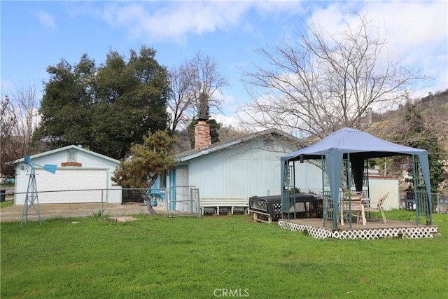 view of side of property featuring a gazebo, a yard, an outbuilding, and a garage