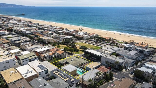 drone / aerial view featuring a water view and a view of the beach