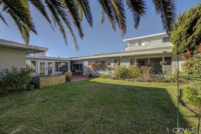 back of house with a lawn