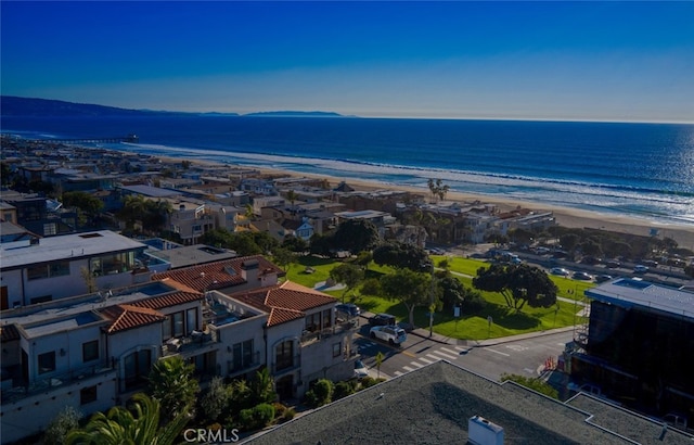 birds eye view of property featuring a beach view and a water view