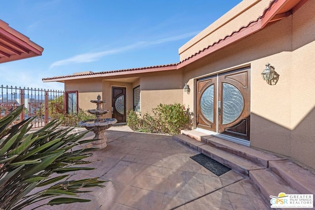 doorway to property featuring a patio area