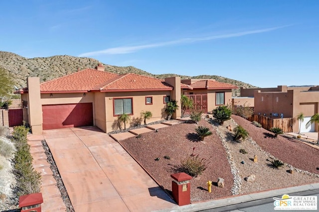 view of front of house featuring a mountain view and a garage