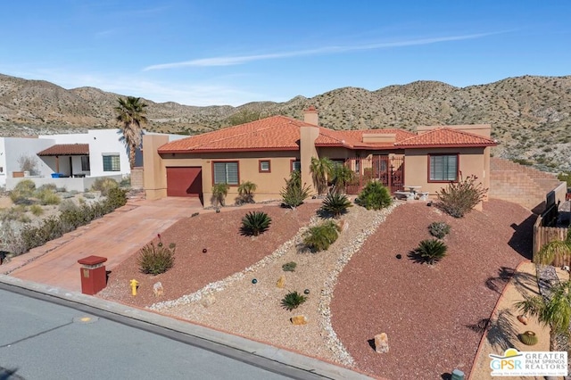 view of front of house featuring a mountain view and a garage