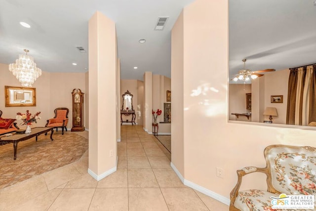 corridor featuring a chandelier and light tile patterned flooring