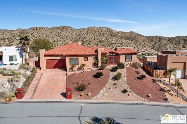 view of front of property featuring a mountain view and a garage