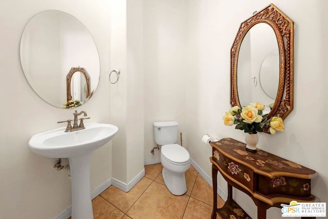 bathroom with tile patterned floors and toilet