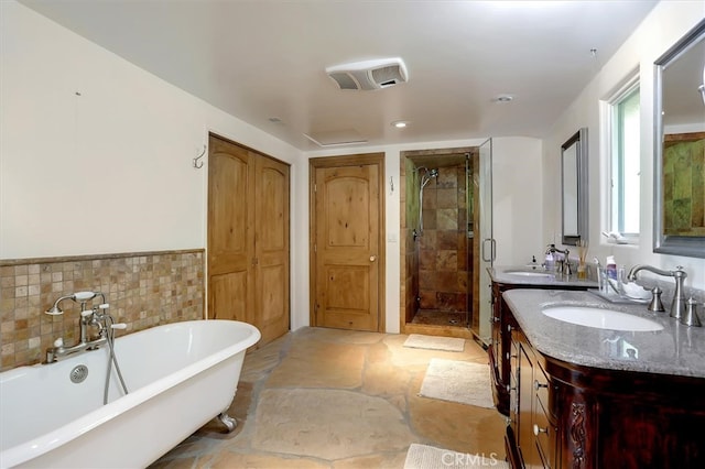 bathroom with vanity, shower with separate bathtub, and tile walls