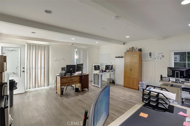 office with beamed ceiling, a wall unit AC, and light wood-type flooring