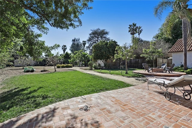 surrounding community featuring a patio area, a fire pit, and a lawn