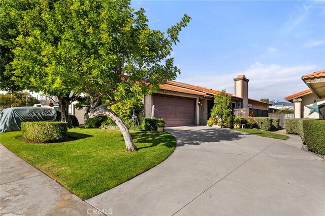 view of front of property featuring a garage and a front lawn