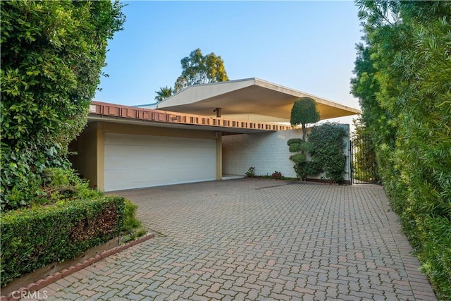 1470 Laurel Way, Beverly Hills, CA 90210 - view of front of home with decorative driveway, an attached garage, and a gate