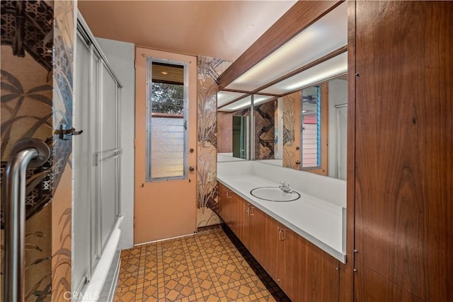 bathroom with tile patterned flooring, vanity, and a shower