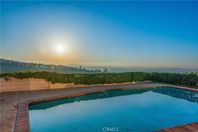 view of pool at dusk