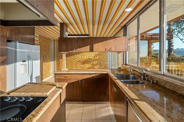 1470 Laurel Way, Beverly Hills, CA 90210 - kitchen with white fridge with ice dispenser, a sink, black electric stovetop, light tile patterned floors, and light stone counters