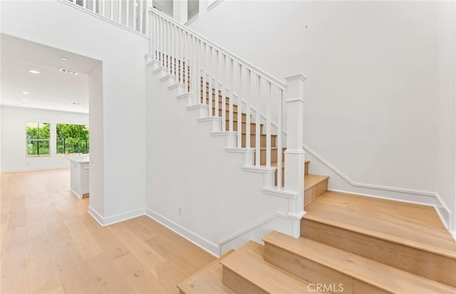 stairway with hardwood / wood-style floors