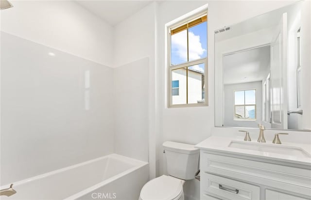 full bathroom featuring plenty of natural light, vanity, tub / shower combination, and toilet