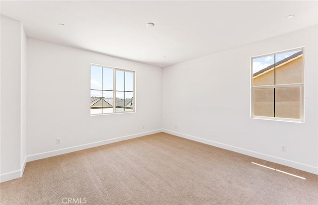 carpeted empty room featuring plenty of natural light