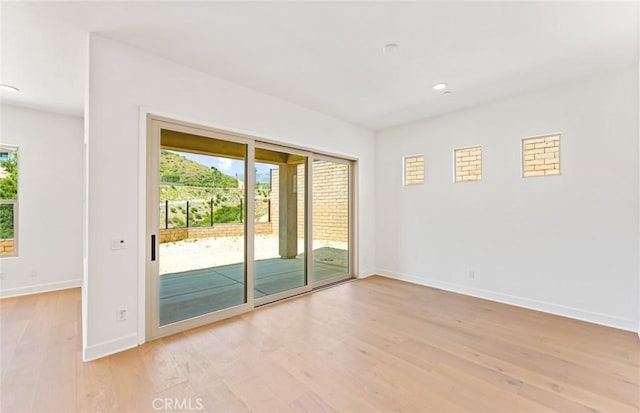 unfurnished room featuring light hardwood / wood-style flooring