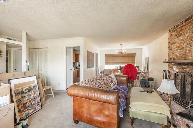 carpeted living room with a chandelier, a brick fireplace, and a textured ceiling