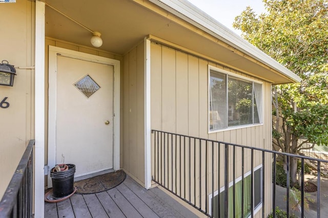 view of exterior entry with a deck