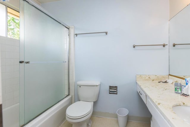 full bathroom featuring vanity, toilet, tile patterned floors, and enclosed tub / shower combo