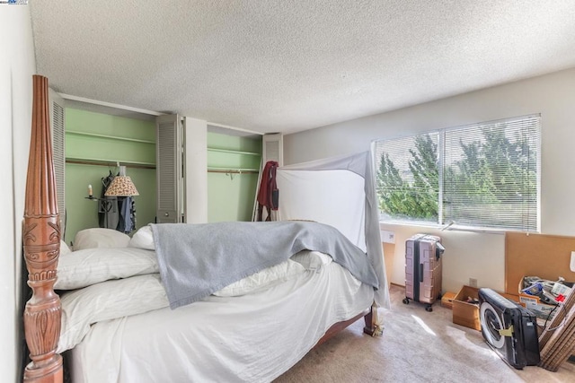 bedroom featuring a textured ceiling and light colored carpet