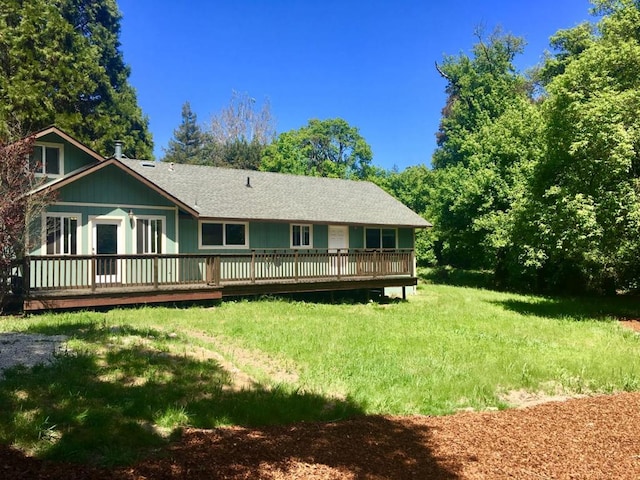 back of house featuring a yard and a wooden deck