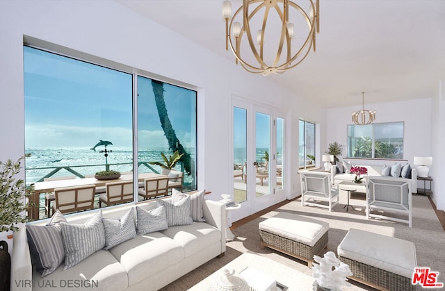 sunroom featuring a water view, a chandelier, and plenty of natural light