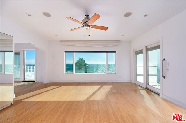 spare room with ceiling fan and light hardwood / wood-style flooring