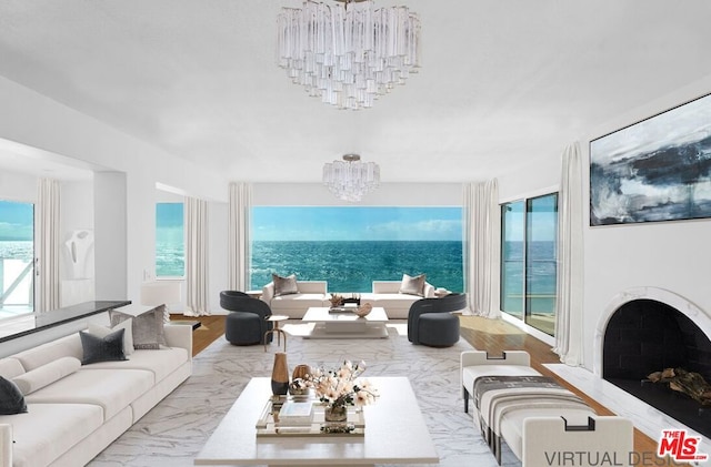 living room with an inviting chandelier and a water view