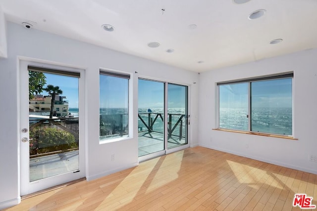 unfurnished room with light hardwood / wood-style flooring