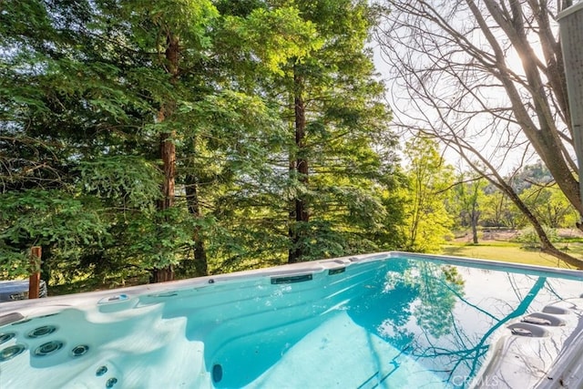 view of pool with a hot tub