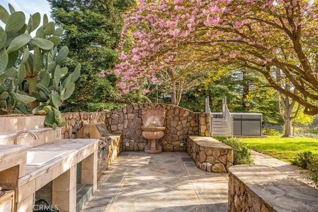 view of patio / terrace featuring grilling area and sink