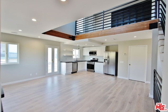 kitchen with white cabinetry, appliances with stainless steel finishes, sink, and plenty of natural light