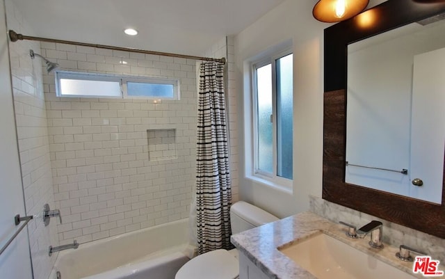 full bathroom with vanity, toilet, and shower / bath combo with shower curtain