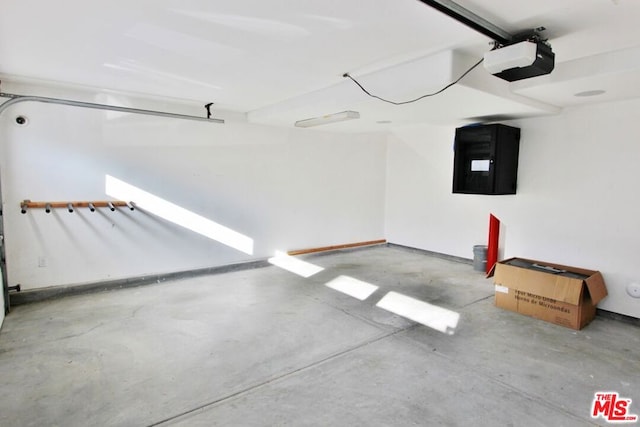 garage featuring a garage door opener and electric panel